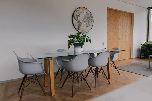 dining room table with gray chairs on a wood floor
