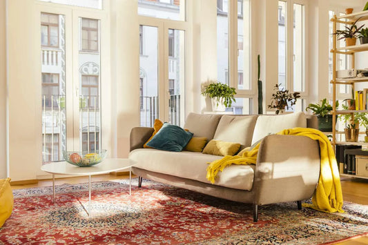 A bright, modern living room with a Persian rug.