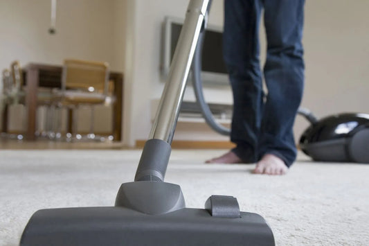 Man vacuuming a carpet