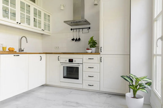 White kitchen interior with marble flooring